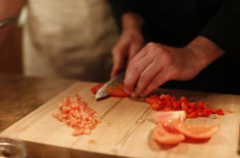 Chef cutting tomato